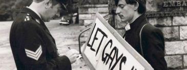 A guard and a man with a protest banner