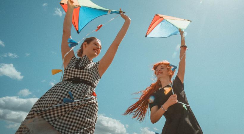 Young women holding kites